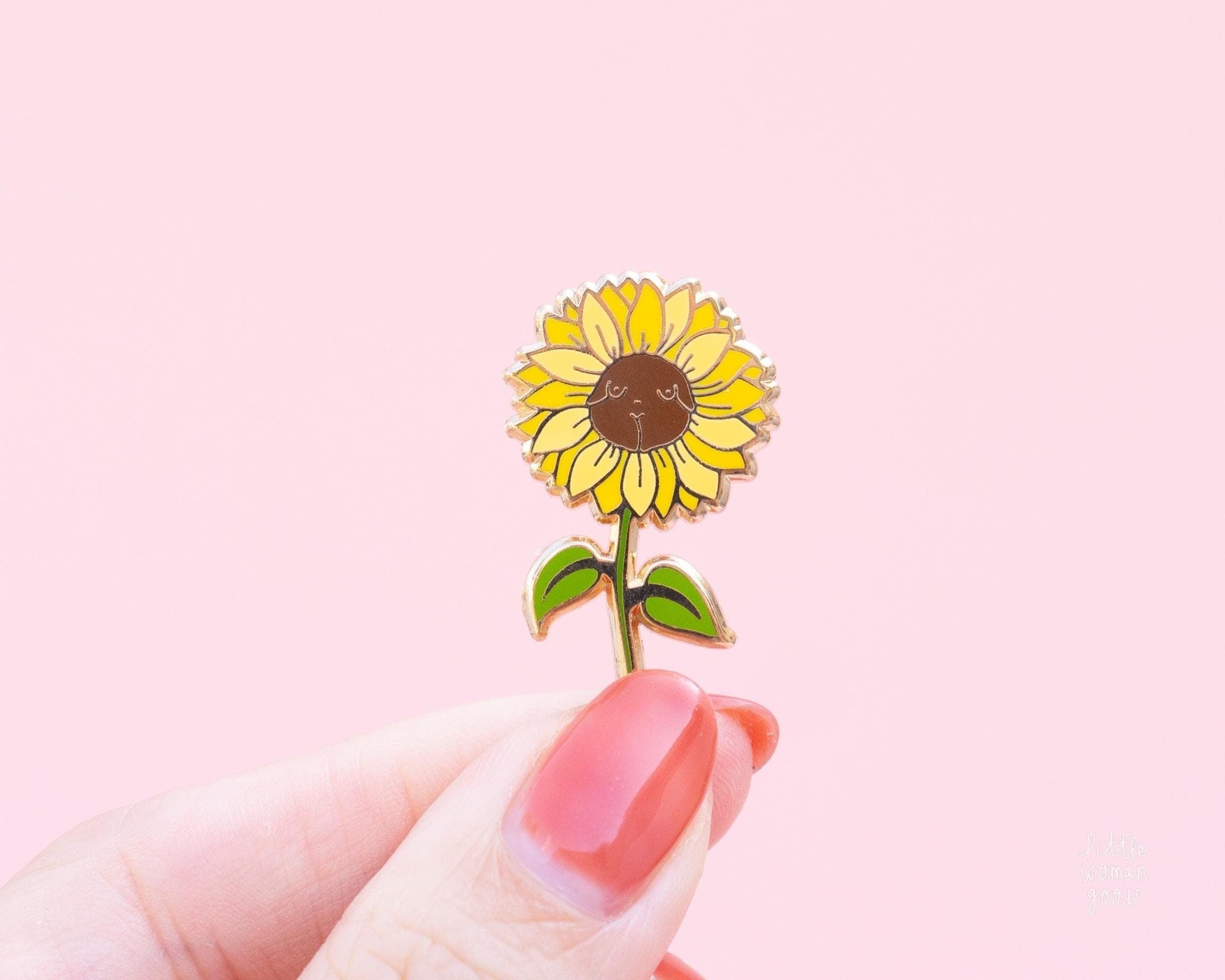 Cute yellow sunflower enamel pin featuring a woman&#39;s body in the center of the sunflower